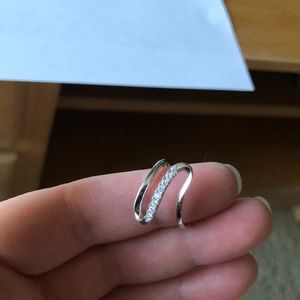 Sterling silver ring with diamonds down middle.